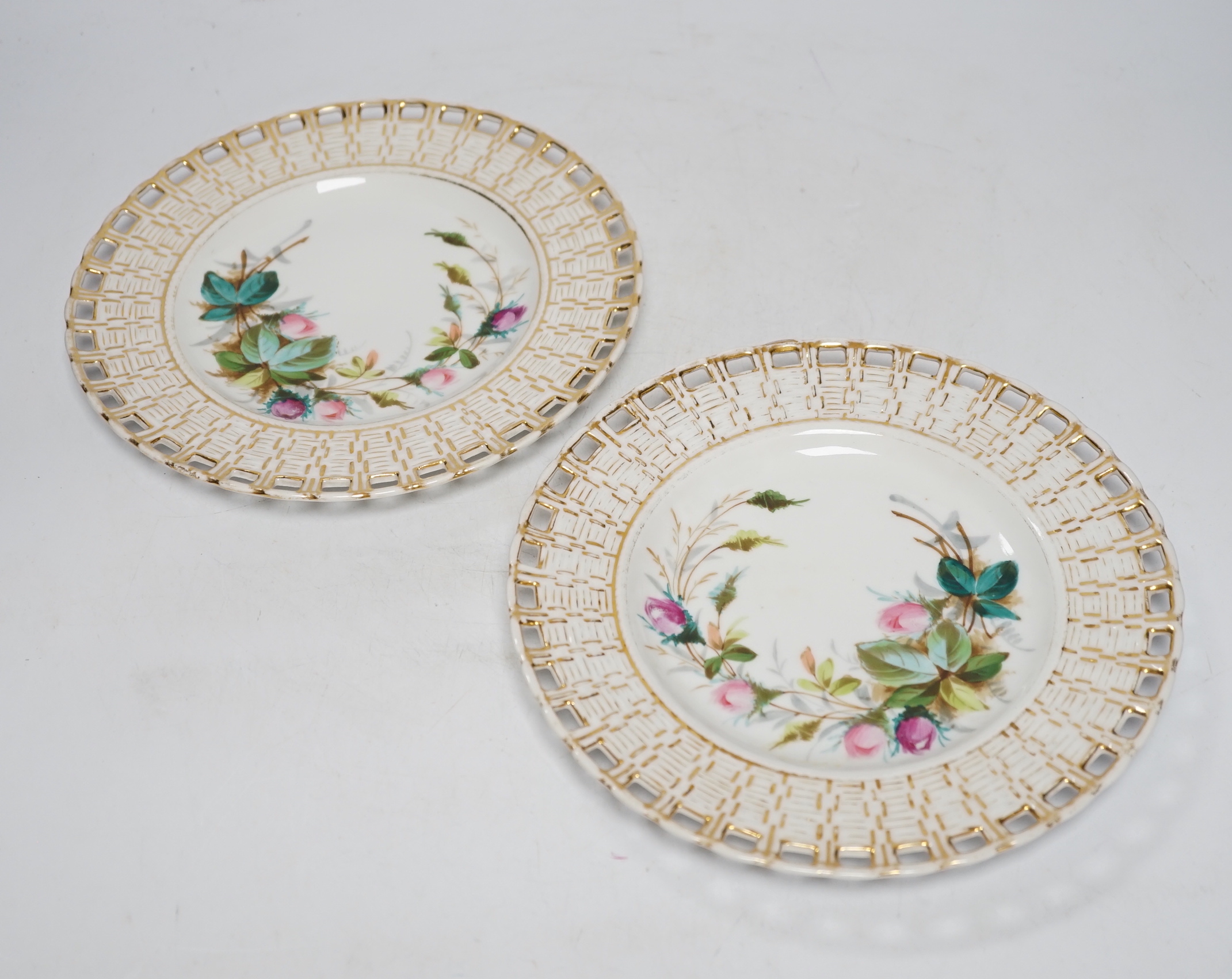 A set of nine French porcelain dessert dishes, painted with roses, and a larger, matching cake dish, (10)